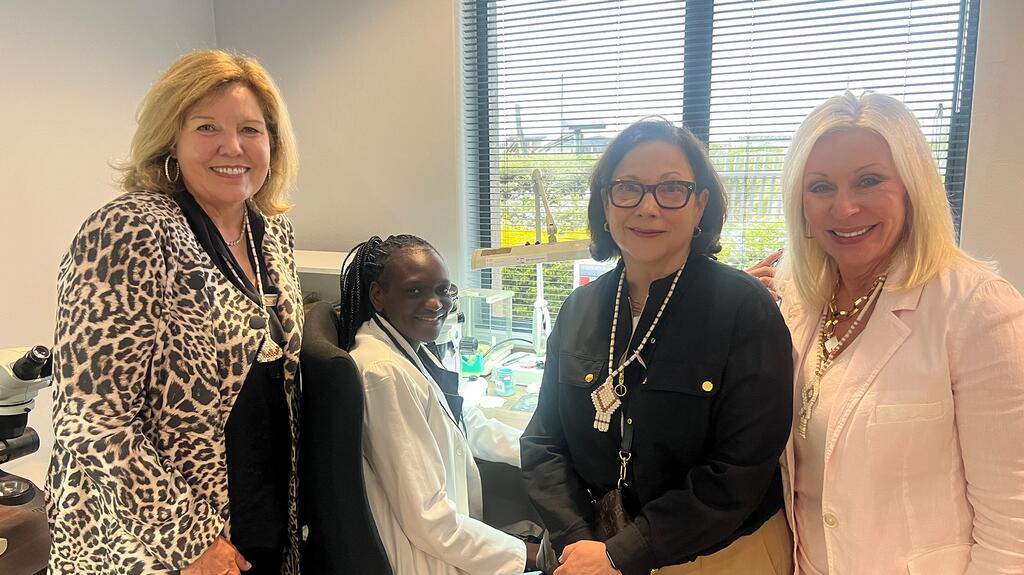 From left, Drosos, Hilson, and Singleton with a diamond factory employee during a recent trip to Botswana Gina Drosos, Joan Hilson, and Jamie Singleton